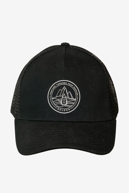 The Every Trail Trucker Hat by Belong Designs is a Black Mountain Brush trucker hat with a curved brim. The front panel showcases a vibrant wavy line design in shades of red, yellow, blue, and white with "BELONG" emblazoned prominently. The back and sides are made of breathable white mesh for added comfort.