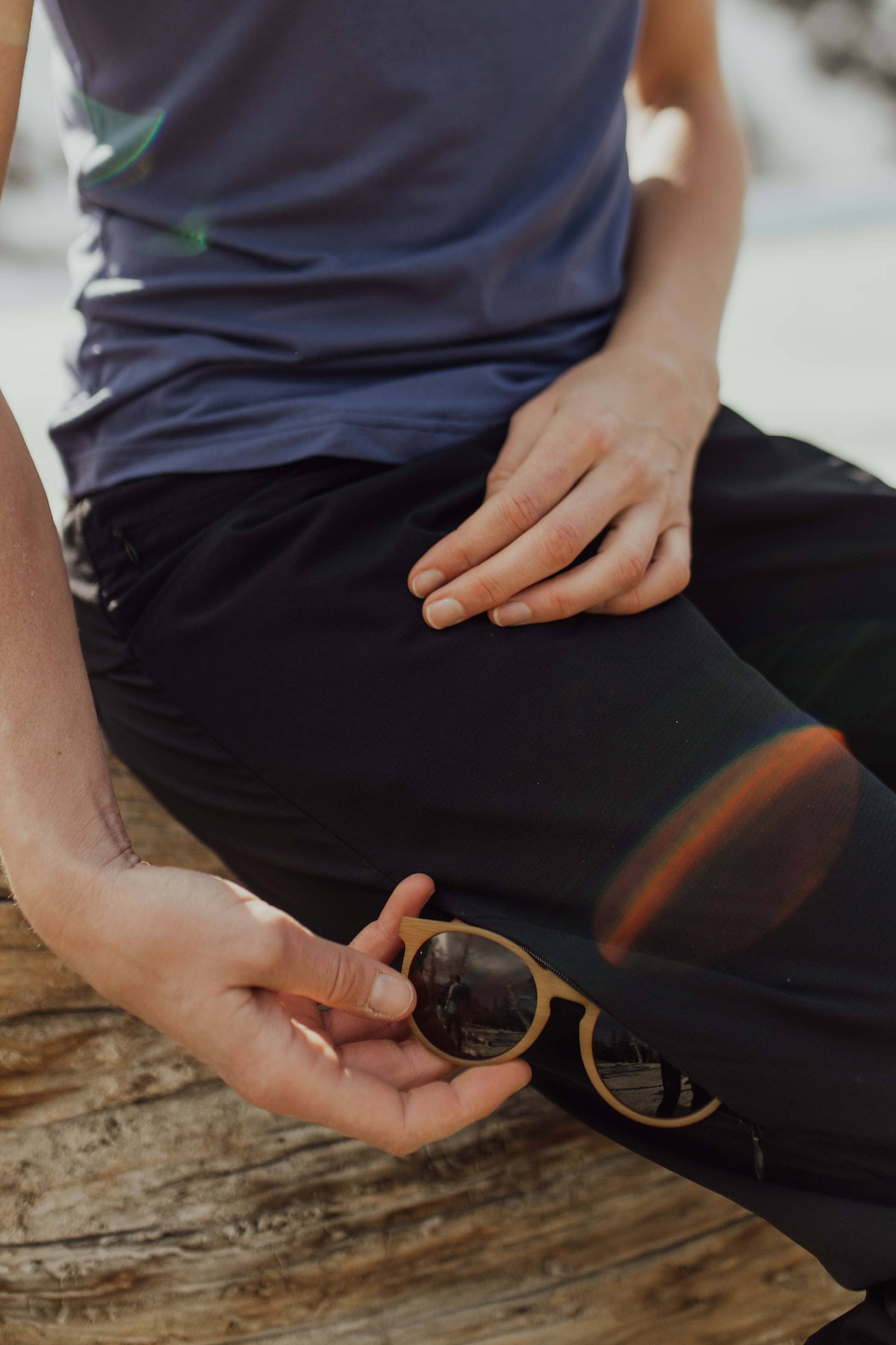 A person wearing Belong Designs' Rocky Mountain Joggers, crafted from durable and stretchy material, stands against a plain background. They are dressed in a dark green cropped top paired with matching athletic pants featuring a drawstring, complemented by brown hiking boots with teal laces. The image is cropped to show the midriff down.
