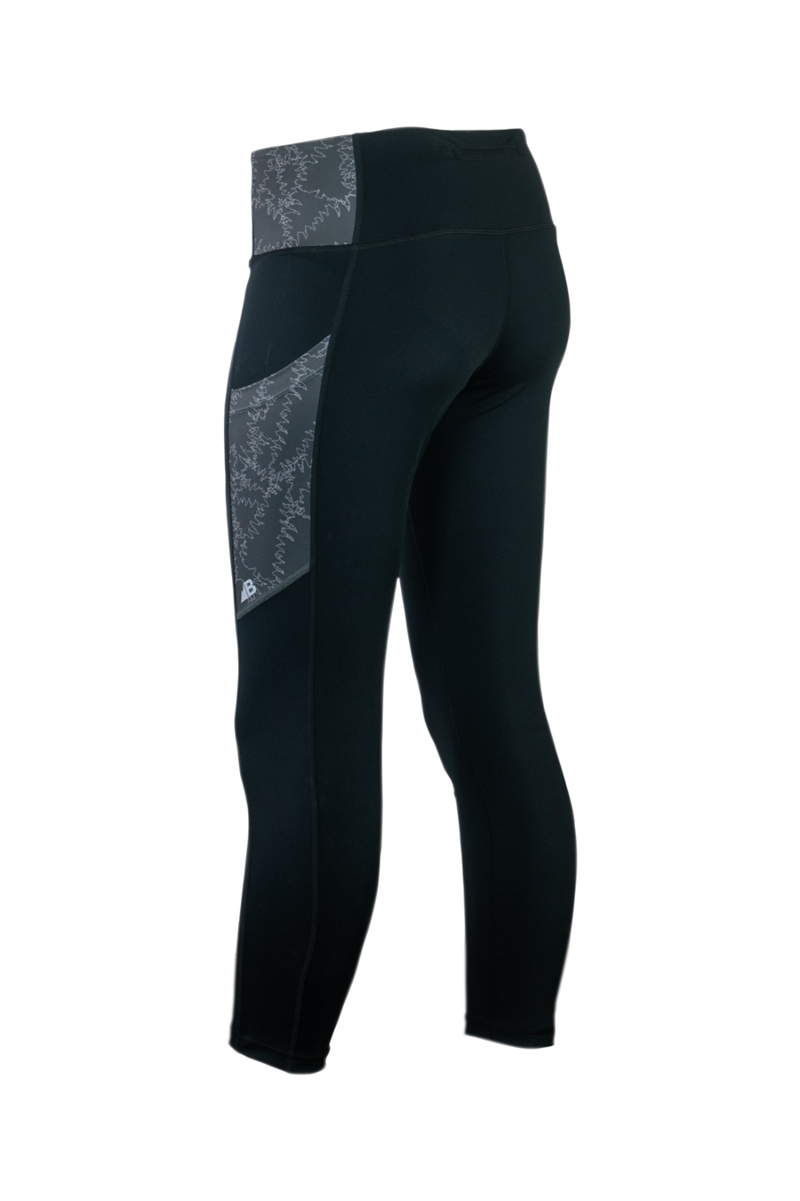 The Trailhead 7/8 Leggings from Belong Designs are black athletic leggings with a high waist and calf-length cut. They feature a colorful striped pattern in shades of purple and blue on the waist and leg panels. Crafted from PrimaFlex material, these multi-pocketed leggings also display a small logo on the left leg against a white background.